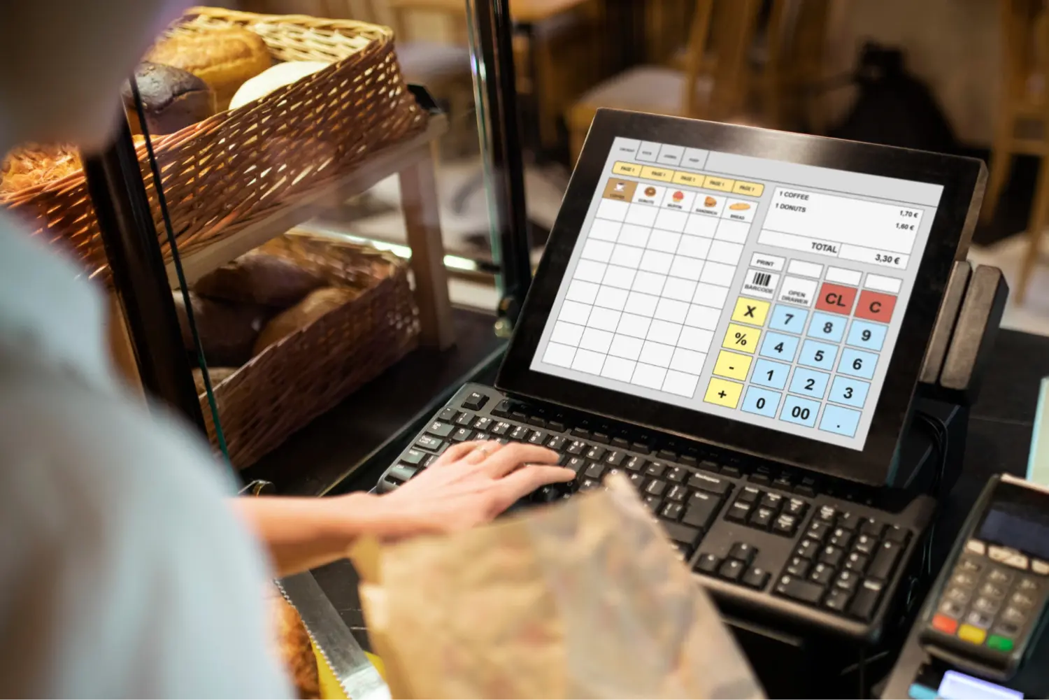 POS terminal beside a pastry display in a cafe