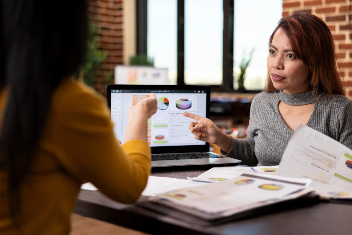 A team analyzes customer satisfaction survey results alongside purchase data