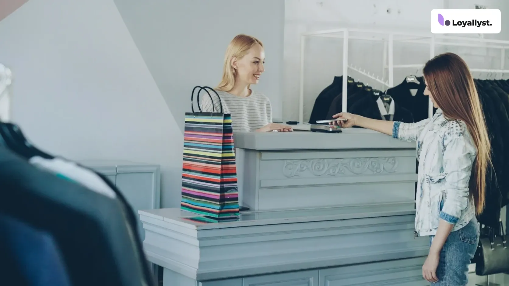A returning customer pays by smartphone in a store, with receipts, a calendar, and the Loyallyst logo nearby