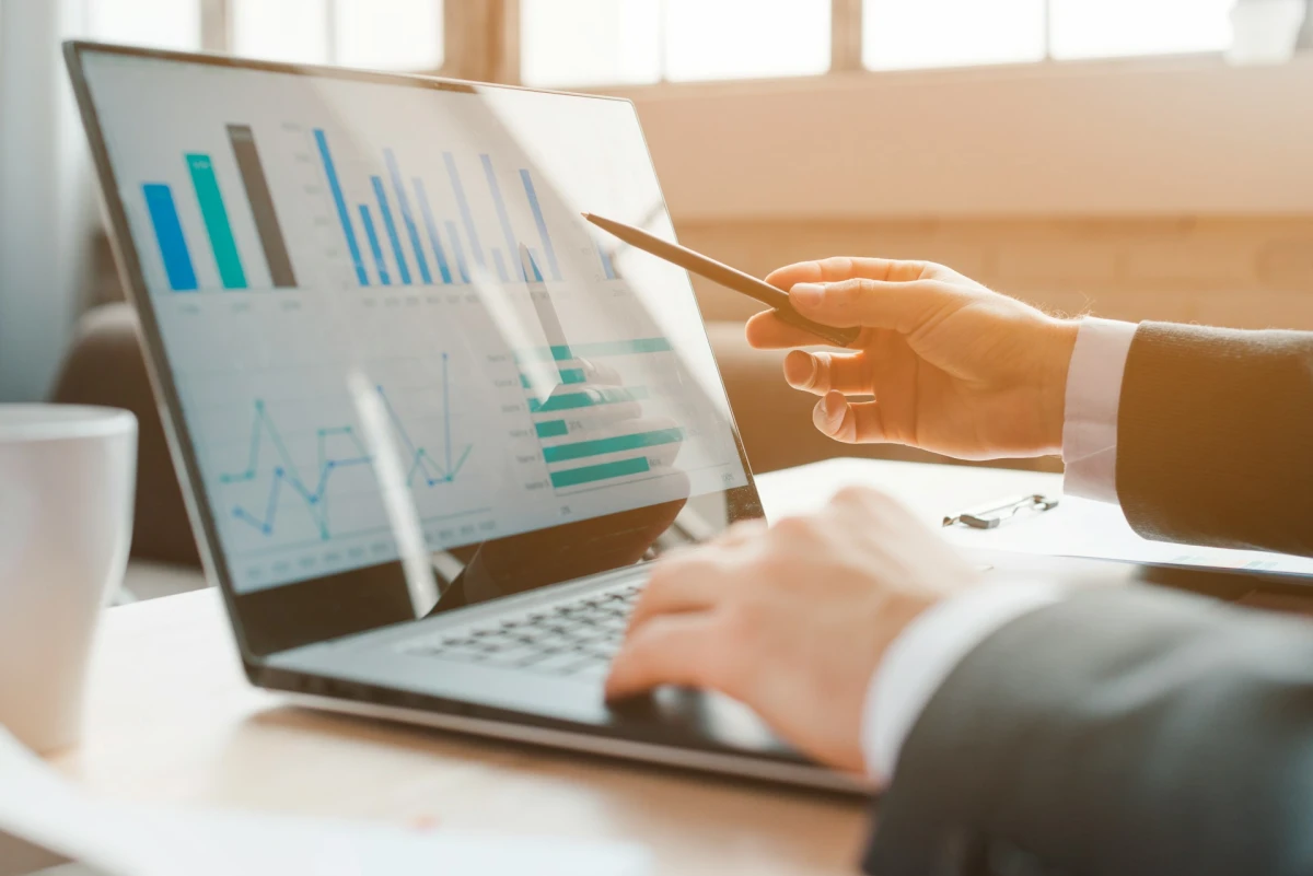 An analyst reviews purchase charts on a laptop
