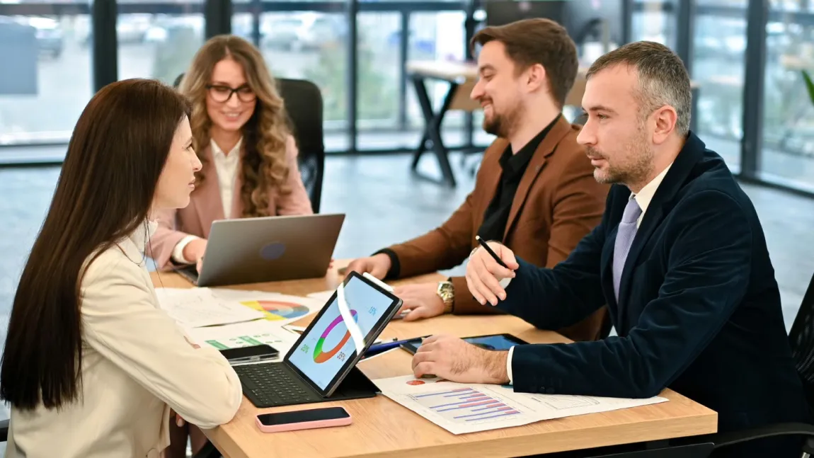 A team discusses customer data and business metrics around a table