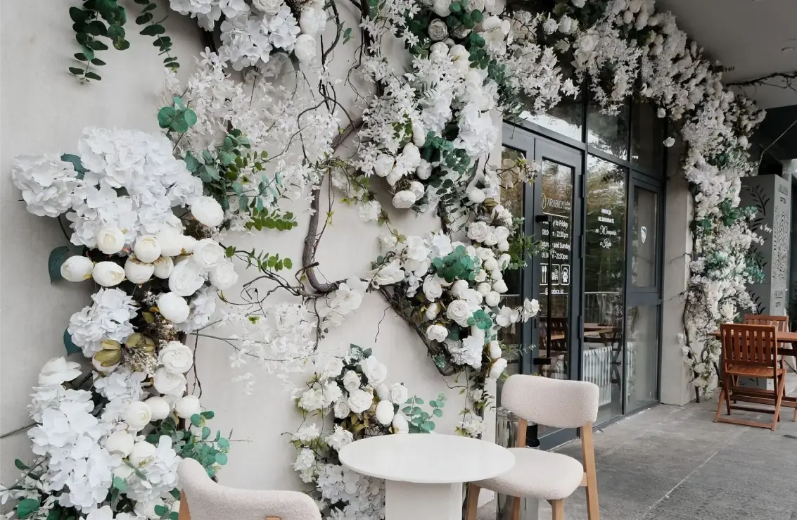 Arabica coffee shop entrance decorated with white flowers